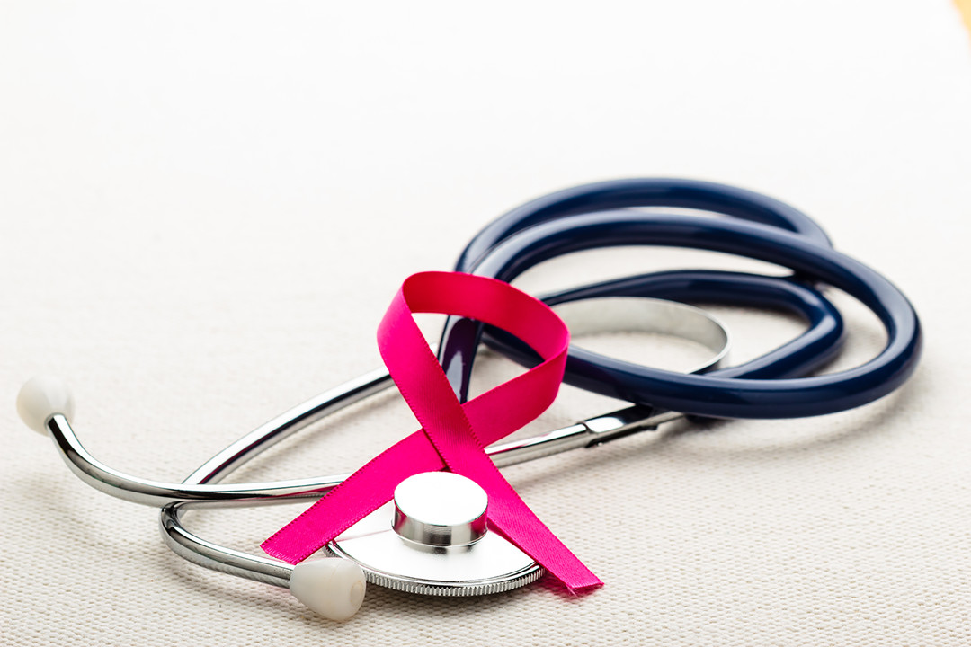 Healthcare, medicine and breast cancer awareness concept. Closeup pink ribbon on stethoscope.